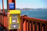 Sign and phone installed on the Golden Gate bridge, known as a hotspot, before barrier was installed